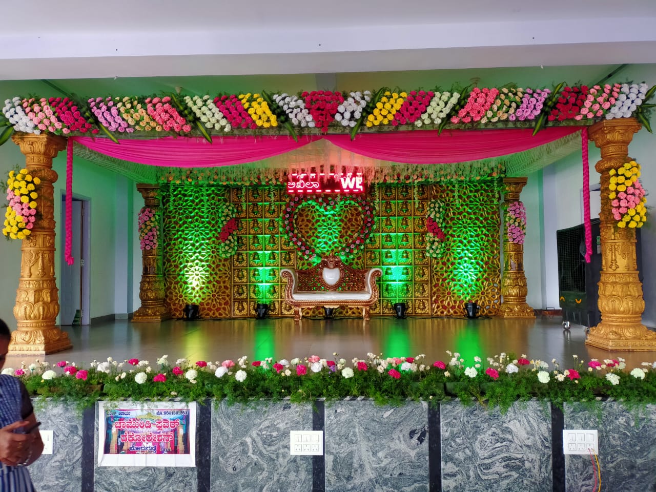 Decorated wedding stage with mandap pillars